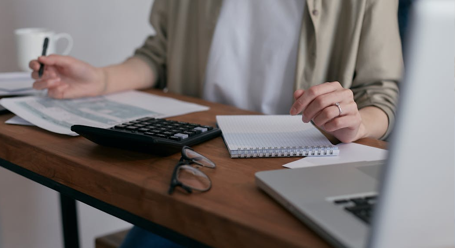 Accounting Career Paths Advisory vs Compliance Accounting and Systems Explained 2 Financial professional reviewing paperwork and calculating data